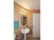 Bathroom featuring pedestal sink, bright lighting, and a neutral color scheme at 10218 N 12Th Pl # 2, Phoenix, AZ 85020