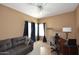 Cozy bedroom with a ceiling fan, sofa, desk, and plenty of natural light from the windows at 10218 N 12Th Pl # 2, Phoenix, AZ 85020