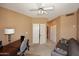 Comfortable bedroom featuring a ceiling fan, desk, couch, and dual door closet access at 10218 N 12Th Pl # 2, Phoenix, AZ 85020