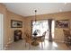 Well-lit dining room with a round wooden table, chandelier, and a sliding door to the patio at 10218 N 12Th Pl # 2, Phoenix, AZ 85020