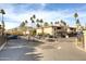 Gated community entrance with lush landscaping and mature palm trees at 10218 N 12Th Pl # 2, Phoenix, AZ 85020