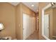 Neutral hallway featuring a large mirror and white double-door closet for ample storage at 10218 N 12Th Pl # 2, Phoenix, AZ 85020