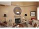 Cozy living room featuring a fireplace with a decorative mirror and comfortable seating at 10218 N 12Th Pl # 2, Phoenix, AZ 85020