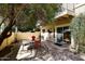 Cozy patio area with red brick pavers, shade trees, and a table set for outdoor dining at 10218 N 12Th Pl # 2, Phoenix, AZ 85020