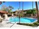 Community pool surrounded by palm trees and lounge chairs, creating a resort-like atmosphere at 10218 N 12Th Pl # 2, Phoenix, AZ 85020