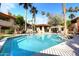 Resort-style community pool with palm trees and lounge chairs at 10218 N 12Th Pl # 2, Phoenix, AZ 85020