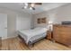 Cozy bedroom featuring a neutral color palette, ceiling fan, and light wood floors at 10226 W Snead S Cir, Sun City, AZ 85351