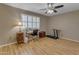 Home office featuring bright natural light, wood laminate flooring, and neutral color palette at 10226 W Snead S Cir, Sun City, AZ 85351