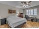 Sunlit bedroom with hardwood floors, ceiling fan, and ample natural light at 10226 W Snead S Cir, Sun City, AZ 85351