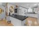 Open-concept kitchen with white cabinets, a breakfast bar, and a view of the dining area at 10226 W Snead S Cir, Sun City, AZ 85351