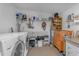 Bright laundry room featuring a washing machine, dryer, shelving, and tool storage at 10226 W Snead S Cir, Sun City, AZ 85351