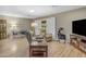 Inviting living room featuring cozy recliners, warm wood floors, and bright natural light at 10226 W Snead S Cir, Sun City, AZ 85351