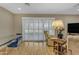 Bright living room with a dining area, large window and comfortable seating at 10226 W Snead S Cir, Sun City, AZ 85351