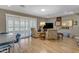 Spacious living room area with a large window with plantation shutters and hardwood floors at 10226 W Snead S Cir, Sun City, AZ 85351