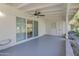 A covered patio with sliding glass doors and a ceiling fan offers outdoor living space at 10226 W Snead S Cir, Sun City, AZ 85351