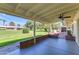 Covered patio with ceiling fan overlooking a large green lawn at 10226 W Snead S Cir, Sun City, AZ 85351