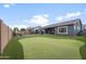 Backyard featuring a putting green, a pool, grass and an outdoor seating area at 10322 E Topaz Ave, Mesa, AZ 85212