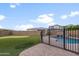 Fenced backyard featuring a custom pool with rock waterfall, plus putting green for leisure and play at 10322 E Topaz Ave, Mesa, AZ 85212