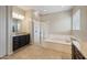 Luxurious bathroom featuring a soaking tub, glass-enclosed shower, and granite countertops at 10322 E Topaz Ave, Mesa, AZ 85212