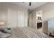 Neutral bedroom with a closet and attached bathroom entrance, illuminated by soft natural light at 10322 E Topaz Ave, Mesa, AZ 85212