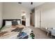 Bright bedroom featuring a patterned quilt, ceiling fan, carpeted floor, ensuite bathroom and white trim at 10322 E Topaz Ave, Mesa, AZ 85212