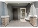 Inviting front porch with decorative columns, custom door, and a welcome mat at 10322 E Topaz Ave, Mesa, AZ 85212