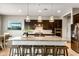 Gourmet kitchen with granite countertops, stainless steel appliances, island seating and dark cabinetry at 10322 E Topaz Ave, Mesa, AZ 85212