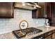 Gourmet kitchen boasts granite counters, stainless appliances, and a stylish subway tile backsplash at 10322 E Topaz Ave, Mesa, AZ 85212
