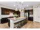 Stylish kitchen with an oversized island, pendant lighting, stainless steel appliances, and dark cabinetry at 10322 E Topaz Ave, Mesa, AZ 85212