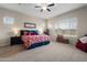 Comfortable main bedroom with soft carpet, natural light, and a ceiling fan at 10322 E Topaz Ave, Mesa, AZ 85212