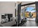 Modern dining room with a fireplace and beautiful outdoor views of an artistic statue and mountains at 10324 E Calle De Las Brisas --, Scottsdale, AZ 85255