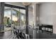 Elegant dining room with modern chandelier, sleek black table, and floor-to-ceiling windows with scenic views at 10324 E Calle De Las Brisas --, Scottsdale, AZ 85255