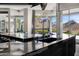 Kitchen island features a waterfall design and stainless steel sink with an exterior view at 10324 E Calle De Las Brisas --, Scottsdale, AZ 85255