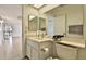 Bathroom with a single sink vanity and a view of the hallway at 10421 E Silvertree Dr, Sun Lakes, AZ 85248