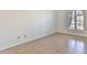 Bright bedroom featuring tile flooring and a window with privacy shutters at 10421 E Silvertree Dr, Sun Lakes, AZ 85248