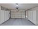 Spacious garage with epoxy floors and ample built-in storage cabinets on both sides at 10421 E Silvertree Dr, Sun Lakes, AZ 85248