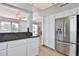 Open kitchen area shows granite counters and stainless steel refrigerator at 10421 E Silvertree Dr, Sun Lakes, AZ 85248