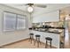 Kitchen area with barstool seating and granite countertops at 10421 E Silvertree Dr, Sun Lakes, AZ 85248