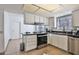 Well-lit kitchen features stainless steel appliances, granite countertops, and white cabinetry at 10421 E Silvertree Dr, Sun Lakes, AZ 85248