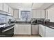 Kitchen with stainless steel appliances, granite countertops, and modern lighting at 10421 E Silvertree Dr, Sun Lakes, AZ 85248