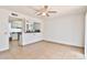 Bright living room features tile flooring, an open kitchen view and ceiling fan at 10421 E Silvertree Dr, Sun Lakes, AZ 85248