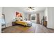 Bright bedroom with wood-look flooring, ceiling fan, and window with patterned curtains at 10942 E Sonrisa Ave, Mesa, AZ 85212