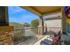 Inviting front porch with stone columns, decorative railing, and comfortable seating with colorful pillows at 10942 E Sonrisa Ave, Mesa, AZ 85212