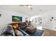 Cozy living room with a leather couch, woven coffee table, and view through French doors at 10942 E Sonrisa Ave, Mesa, AZ 85212