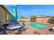 Backyard pool area with patio furniture and a partially shaded dining area at 10942 E Sonrisa Ave, Mesa, AZ 85212