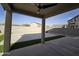 Covered patio overlooks a well-maintained backyard featuring gravel, a concrete patio, and artificial turf, perfect for entertaining at 10968 W Baden St, Avondale, AZ 85323