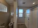 Well-lit bathroom with a toilet and a sleek glass-enclosed shower, designed for comfort and convenience at 10968 W Baden St, Avondale, AZ 85323