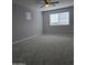 Large bedroom with plush carpet, a ceiling fan, and lots of natural light at 10968 W Baden St, Avondale, AZ 85323