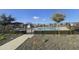 Gated community pool with shaded seating areas, offering a relaxing and enjoyable outdoor amenity at 10968 W Baden St, Avondale, AZ 85323