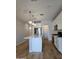 Modern kitchen featuring a large island, pendant lighting, pantry and stainless steel appliances at 10968 W Baden St, Avondale, AZ 85323